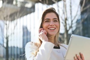 confident businesswoman using her tablet and phone  smiling outdoors in sunlight 300x200 - confident businesswoman using her tablet and phone_ smiling outdoors in sunlight..jpg