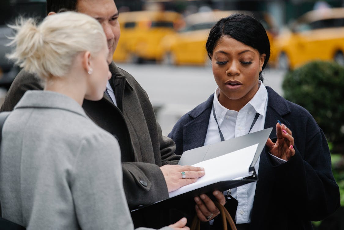 coworkers examining documents on city street - Philadelphia Car Accident Lawyers: Protecting Your Legal Rights