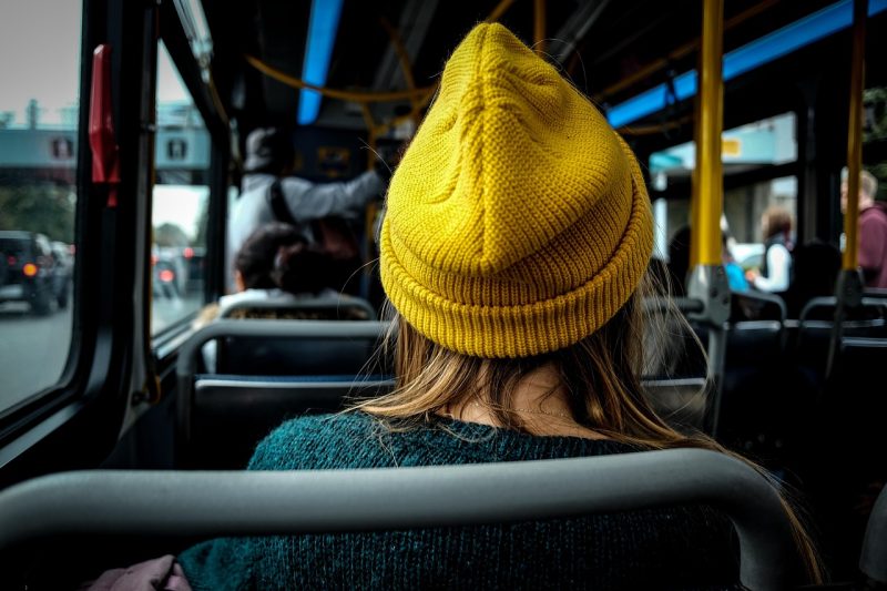 woman wearing a yellow hat inside the bus 800x533 - Top 5 Ways to Improve Your Daily Shuttle Bus Ride