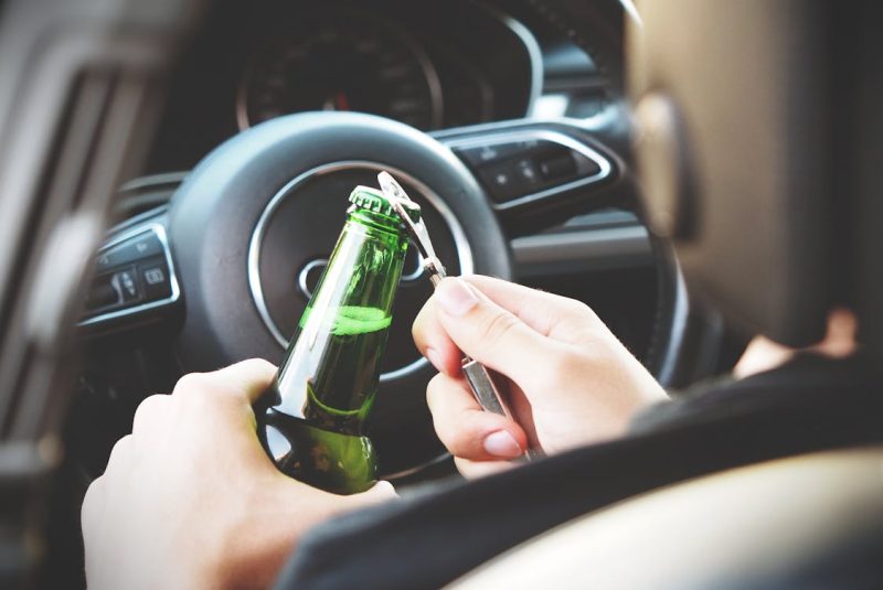 Person Opening Bottle on Car 800x535 - 5 Ways a DUI Lawyer Can Help Reduce Your Penalties
