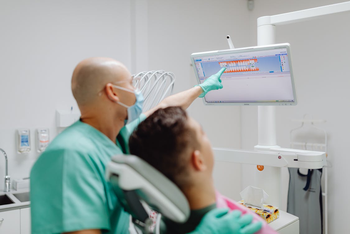Dentist Treating Patient in Clinic - What Makes IT Integration Vital for DSOs Today? Explained