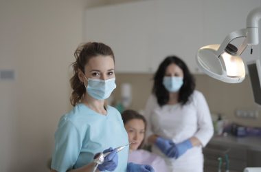 Female dentists treating teeth of patient 380x250 - What Makes IT Integration Vital for DSOs Today? Explained
