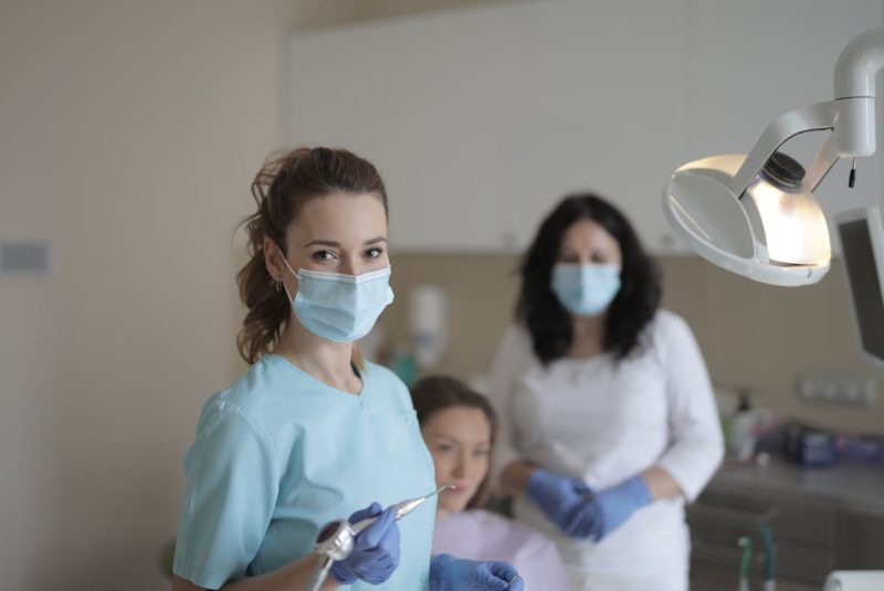 Female dentists treating teeth of patient 800x535 - What Makes IT Integration Vital for DSOs Today? Explained