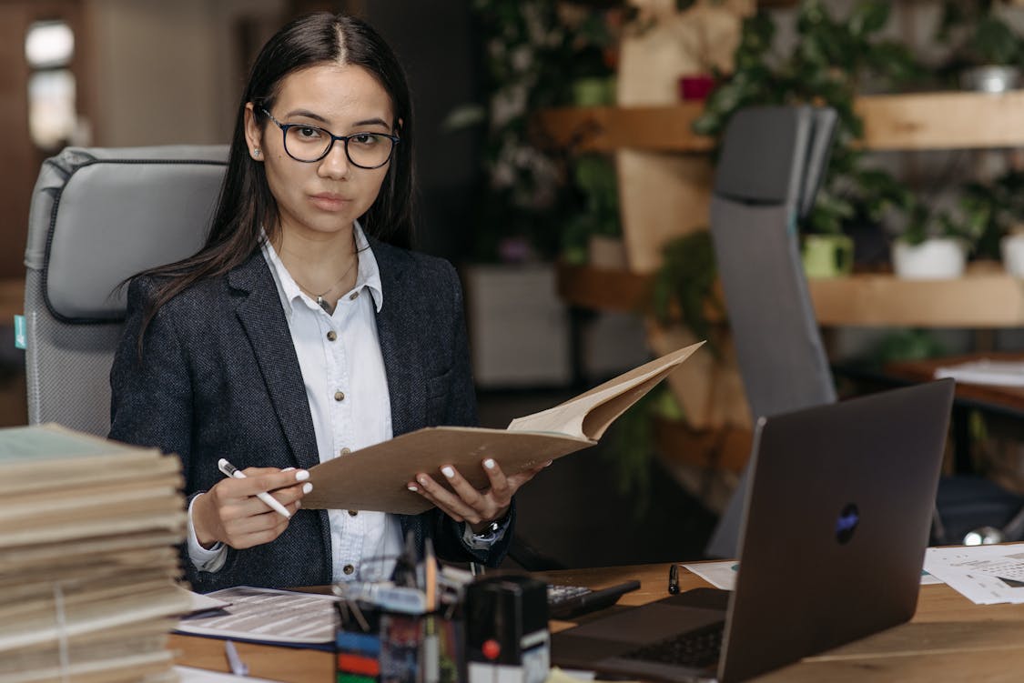 woman holding documents - How to Choose the Right Immigration Lawyer for Your Needs