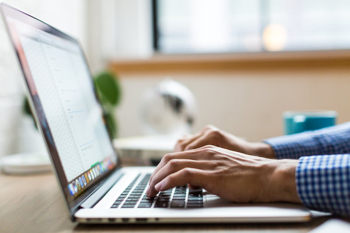a person using a laptop - 5 Reasons Shopify Stores Are Adopting AI SEO Automation