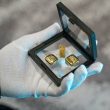 a person wearing gloves holding a glass frame with gold bars 110x110 - How to Choose the Right Gold Assets for Your Goals