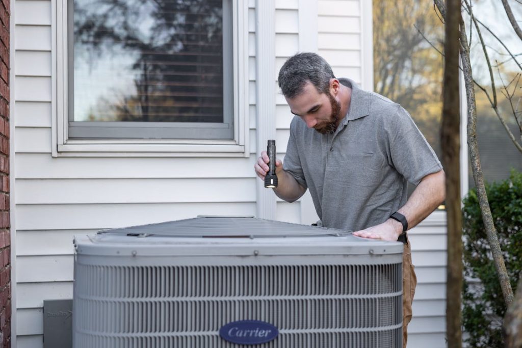 Why London-Area HVAC Contractors Are Booking Installations Six Weeks Out in 2026 A technician inspects an outdoor HVAC unit 1 1024x683 - Why London-Area HVAC Contractors Are Booking Installations Six Weeks Out in 2026