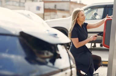 a woman charging her electric car 380x250 - Used Electric Cars Jumped 32% in Three Months, and Families Are Driving Most of It